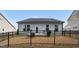 Backyard featuring an outdoor living space, enhancing the home's appeal for relaxation and entertainment at 105 Palladium Ct, Elon, NC 27244