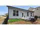 Backyard patio with grill, seating, and artificial turf, offering a low-maintenance outdoor space at 105 Palladium Ct, Elon, NC 27244