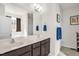 Bathroom featuring a double sink vanity, framed mirror, and plentiful natural light at 105 Palladium Ct, Elon, NC 27244