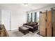 Relaxing bedroom area featuring a leather couch and a small folding screen at 105 Palladium Ct, Elon, NC 27244