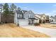 Exterior view of home with a two car garage, adjacent to lawn and other similar homes at 105 Palladium Ct, Elon, NC 27244