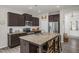 Spacious kitchen featuring a large island with seating, stainless steel appliances, and dark wood cabinets at 105 Palladium Ct, Elon, NC 27244
