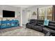 Cozy living room with leather sofa, patterned rug, and a view of the outdoor area at 105 Palladium Ct, Elon, NC 27244