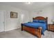 Inviting main bedroom with a decorative bed, ensuite bathroom, and plush carpeting at 105 Palladium Ct, Elon, NC 27244