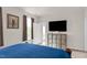 View of the main bedroom featuring TV, storage unit, and balcony entrance at 105 Palladium Ct, Elon, NC 27244