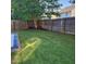 Lush backyard with well-maintained lawn and wooden fencing providing privacy at 108 Palmdale Ct, Holly Springs, NC 27540