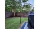Private backyard featuring a well-manicured lawn, wooden fence and tiki torch at 108 Palmdale Ct, Holly Springs, NC 27540