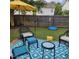 Relaxing backyard patio area with outdoor seating and a yellow umbrella at 108 Palmdale Ct, Holly Springs, NC 27540