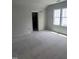 A light color bedroom with a closet and a window provides a peaceful atmosphere at 108 Pointe Park Cir, Holly Springs, NC 27540