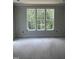 A bedroom with a large window overlooking the backyard and a light color scheme at 108 Pointe Park Cir, Holly Springs, NC 27540