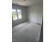 A light color bedroom with two windows provides a relaxing space with natural lighting at 108 Pointe Park Cir, Holly Springs, NC 27540