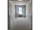 Bright entryway featuring classic wainscoting and a charming wooden front door at 108 Pointe Park Cir, Holly Springs, NC 27540