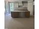 Bright kitchen featuring crisp white cabinets and a large central island at 108 Pointe Park Cir, Holly Springs, NC 27540