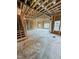 Open-concept living room with exposed framing and stairs leading to the second level at 108 Pointe Park Cir, Holly Springs, NC 27540