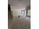 Open-concept living room showcases ample space, large windows, staircase, and natural light at 108 Pointe Park Cir, Holly Springs, NC 27540