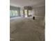 Spacious living area features large windows, outdoor access, and ample natural light at 108 Pointe Park Cir, Holly Springs, NC 27540