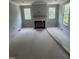 Open living room featuring a fireplace and large windows offering natural light at 108 Pointe Park Cir, Holly Springs, NC 27540