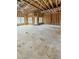 Large open-concept living room featuring exposed wood framing and multiple windows and door at 108 Pointe Park Cir, Holly Springs, NC 27540