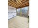 Outdoor screened porch with wood flooring and a view of the wooded backyard at 108 Pointe Park Cir, Holly Springs, NC 27540