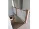 A wooden staircase features a white railing design and leads to the upper level of the home at 108 Pointe Park Cir, Holly Springs, NC 27540