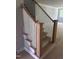A wooden staircase with white railings and trim leads upstairs in the house at 108 Pointe Park Cir, Holly Springs, NC 27540