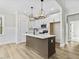 Bright kitchen with white cabinets, a center island, pendant lights, and stainless steel appliances at 111 Averly Ct, Stem, NC 27581