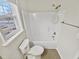 A bathroom with a toilet and bathtub that are bright white at 117 Woodson Dr, Clayton, NC 27527