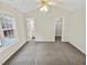 Bedroom features ceiling fan, window, a closet, and a partial view of the bathroom at 117 Woodson Dr, Clayton, NC 27527