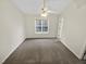 This bedroom features a ceiling fan and a window overlooking the lawn at 117 Woodson Dr, Clayton, NC 27527