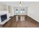 Spacious living room with fireplace, hardwood floors, and natural light at 117 Woodson Dr, Clayton, NC 27527