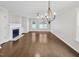 Bright living room with hardwood floors, a fireplace and large windows overlooking the backyard at 117 Woodson Dr, Clayton, NC 27527
