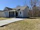 Beautiful single-story home with a long concrete driveway, a covered porch, and manicured front yard at 119 Daniel St, Oxford, NC 27565