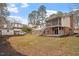 View of the home's backyard, featuring a two-story deck, brick exterior, fenced yard, and a detached shed at 1203 Brookgreen Dr, Cary, NC 27511