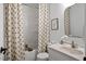 Cozy bathroom featuring patterned shower curtains, a tiled shower, and a marble countertop at 1203 Brookgreen Dr, Cary, NC 27511