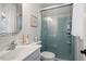 Well-lit bathroom with a glass-enclosed shower, light blue tiles, and a modern vanity with sink at 1203 Brookgreen Dr, Cary, NC 27511