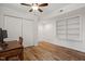 Bright bedroom with wood-look flooring, ceiling fan, and closet, ideal for home office setup at 1203 Brookgreen Dr, Cary, NC 27511