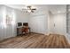 Bright bedroom with wood-look flooring, ceiling fan, and closet, ideal for home office setup at 1203 Brookgreen Dr, Cary, NC 27511