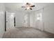 Bright bedroom with carpet, white walls, and a window, adjacent to a walk-in closet and bathroom at 1203 Brookgreen Dr, Cary, NC 27511