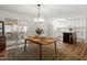 Bright dining space open to the kitchen and patio, features a wood table and modern lighting at 1203 Brookgreen Dr, Cary, NC 27511