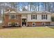 Charming two-story home with brick and siding exterior, manicured lawn, and double door entrance at 1203 Brookgreen Dr, Cary, NC 27511