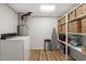 Bright laundry room with washer, dryer, and lots of storage at 1203 Brookgreen Dr, Cary, NC 27511