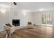 Spacious living area with wood-look flooring, fireplace, and sliding door to the outdoor patio at 1203 Brookgreen Dr, Cary, NC 27511