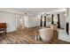 Open-concept living room with wood-look flooring, recessed lighting, and bright natural light at 1203 Brookgreen Dr, Cary, NC 27511