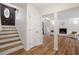 Inviting foyer showcasing a staircase leading to a bright living room with fireplace at 1203 Brookgreen Dr, Cary, NC 27511