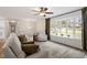 Bright living room featuring large windows, neutral decor, comfortable seating, and a ceiling fan at 1203 Brookgreen Dr, Cary, NC 27511