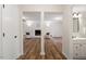 Open-concept living room with hardwood floors, fireplace, and access to a well lit bathroom at 1203 Brookgreen Dr, Cary, NC 27511