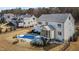 Aerial view of a luxurious backyard with a sparkling pool, patio, and well-manicured landscaping at 1225 Perry Bluff Dr, Wake Forest, NC 27587