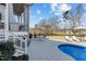 Backyard patio with pool, lounge chairs, dining table and view of surrounding neighborhood at 1225 Perry Bluff Dr, Wake Forest, NC 27587