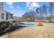 Extensive backyard with multiple seating areas, pool, barbecue and view of neighboring properties at 1225 Perry Bluff Dr, Wake Forest, NC 27587