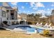 Beautiful backyard oasis featuring a sparkling pool, lounge chairs, and outdoor dining area at 1225 Perry Bluff Dr, Wake Forest, NC 27587